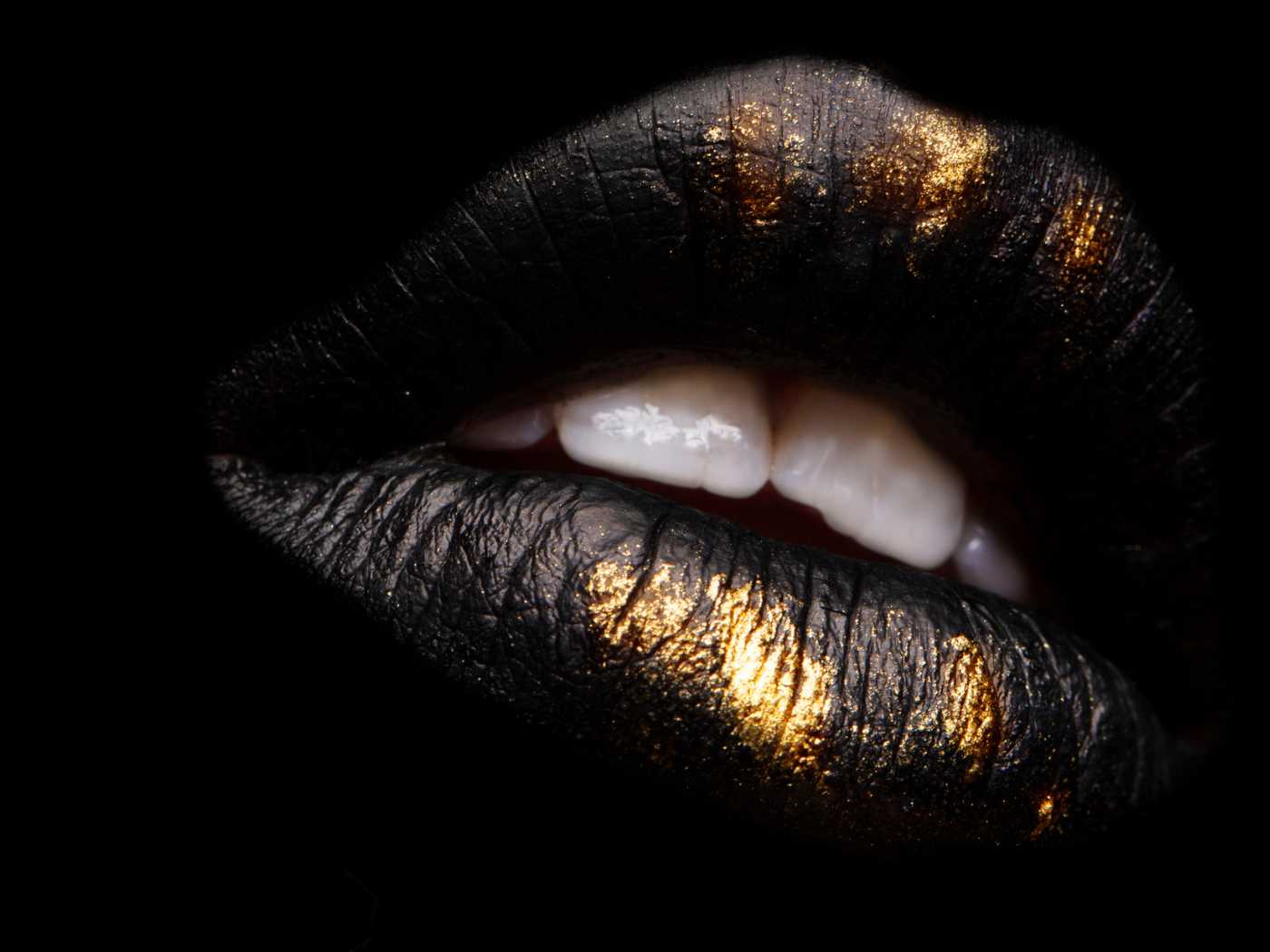 Lips with black and gold lip color