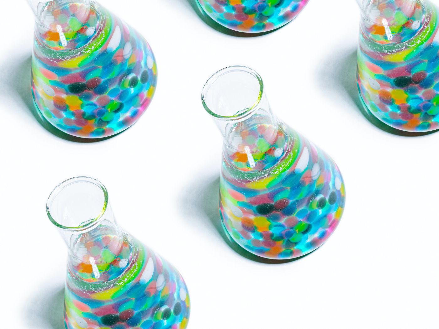 Beakers filled with bubbles of varying colors