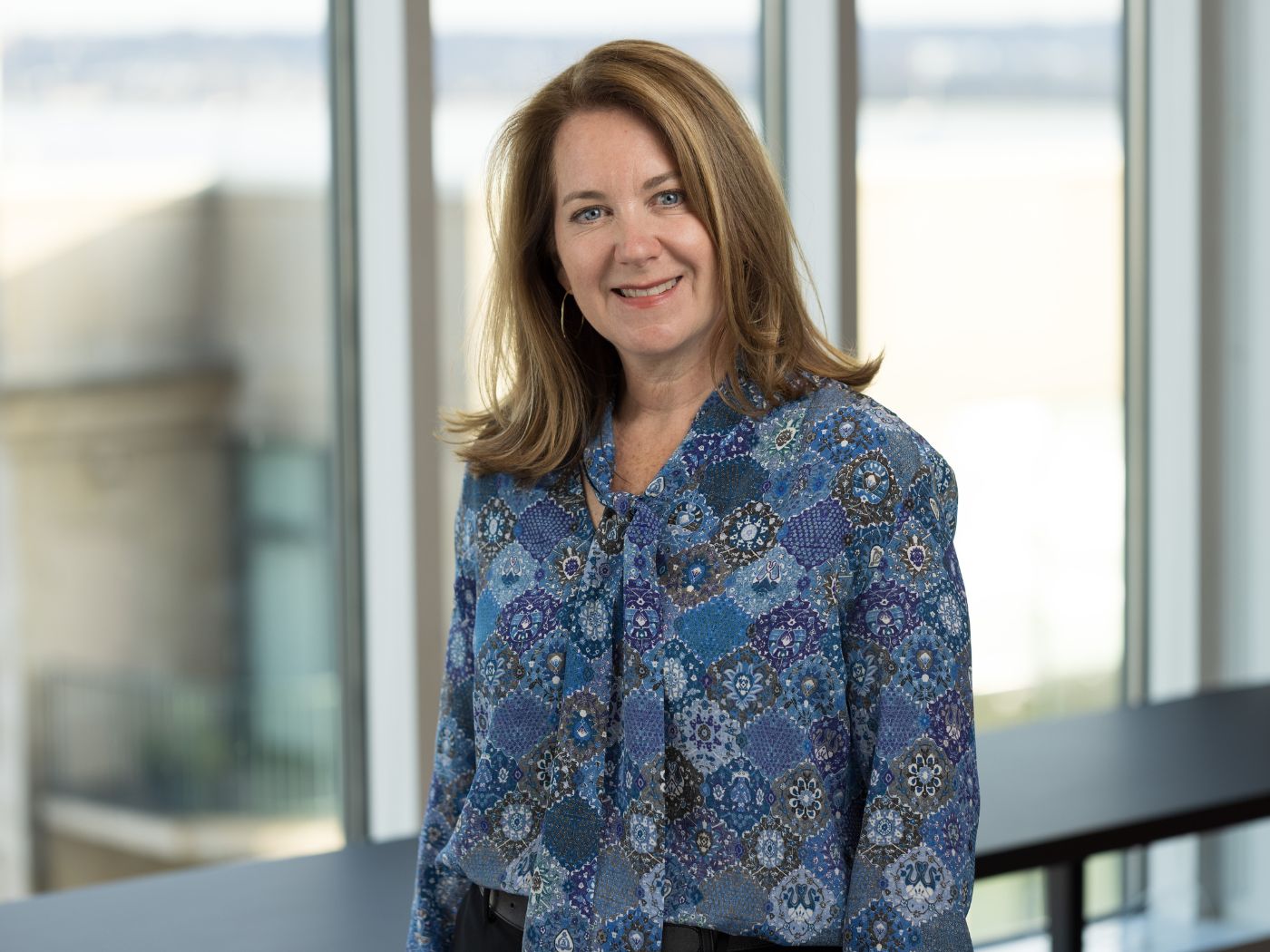 Kelly McPhilliamy standing in an office building