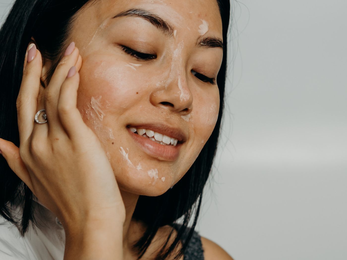 Woman applying face mask