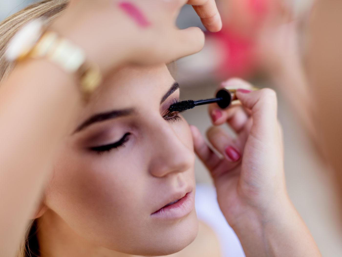 Make up artist applying mascara to a model