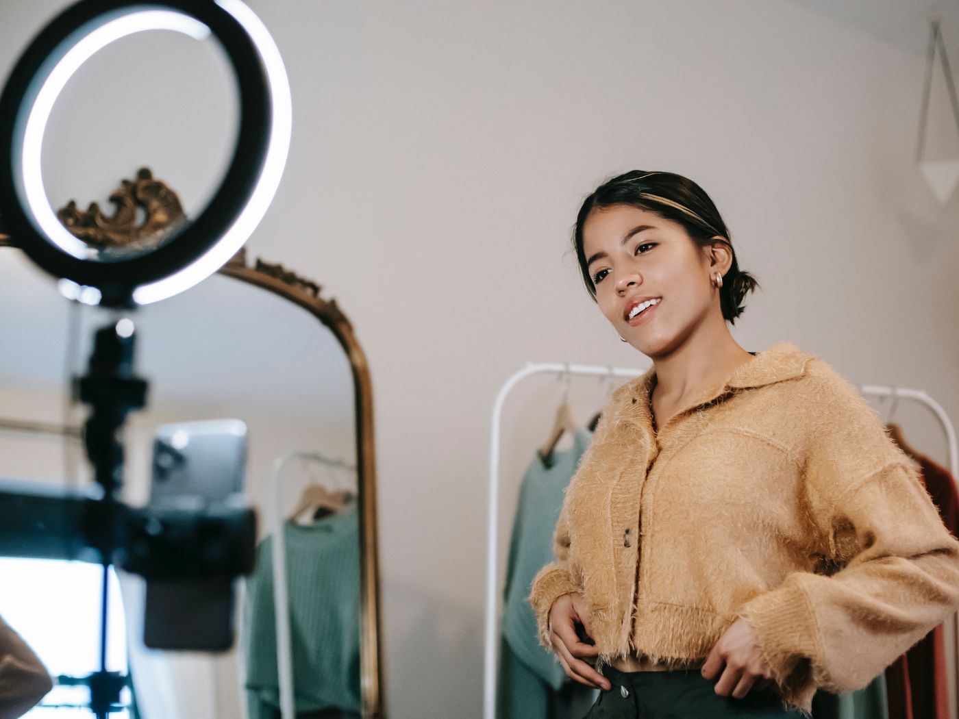 Woman recording a TikTok video in front of a ring light