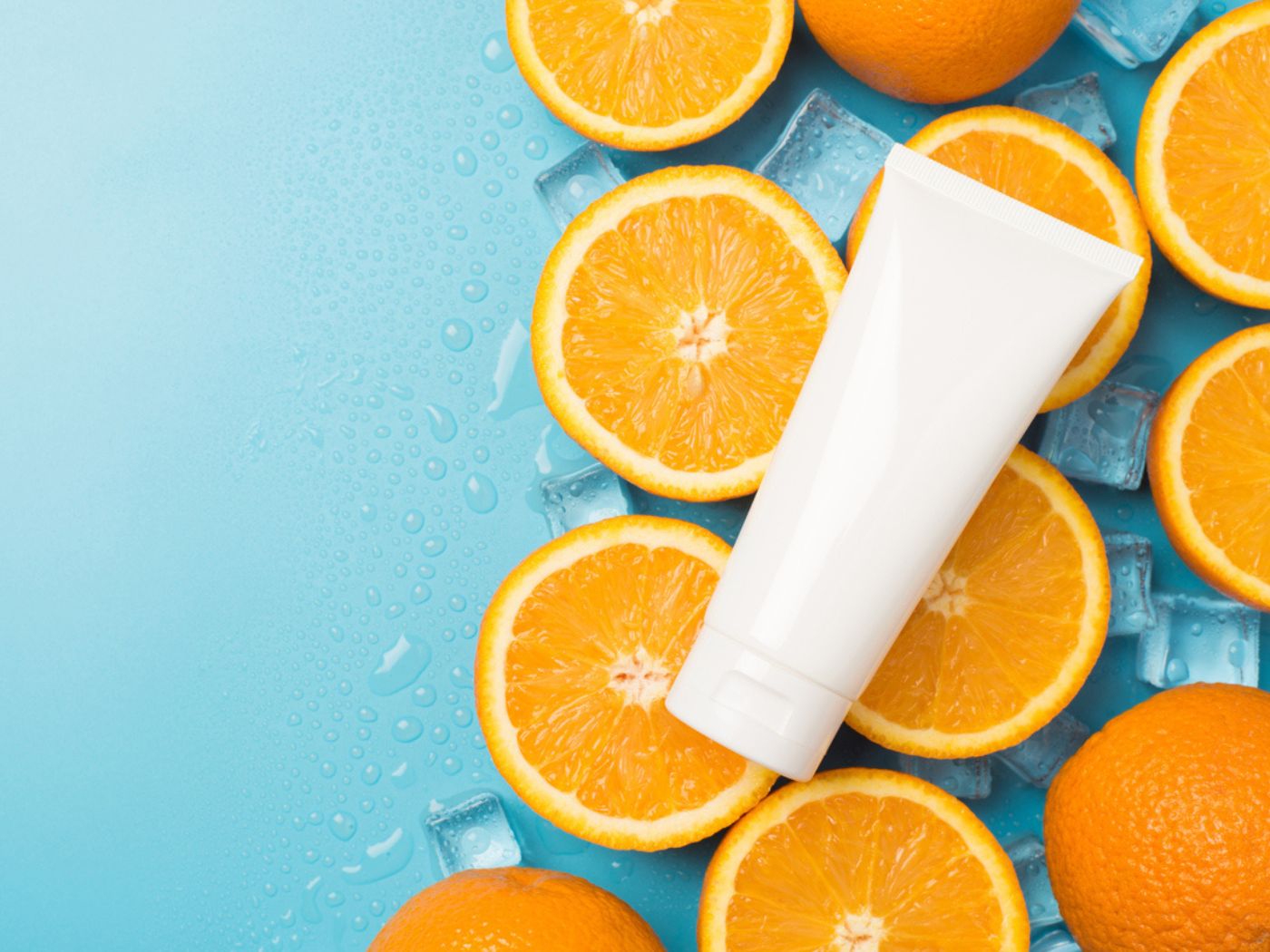 White shampoo bottle on top of orange slices